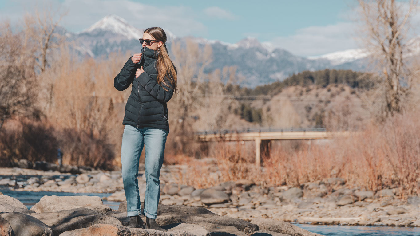 Lady wearing VOORMI Black Puffy next to the river