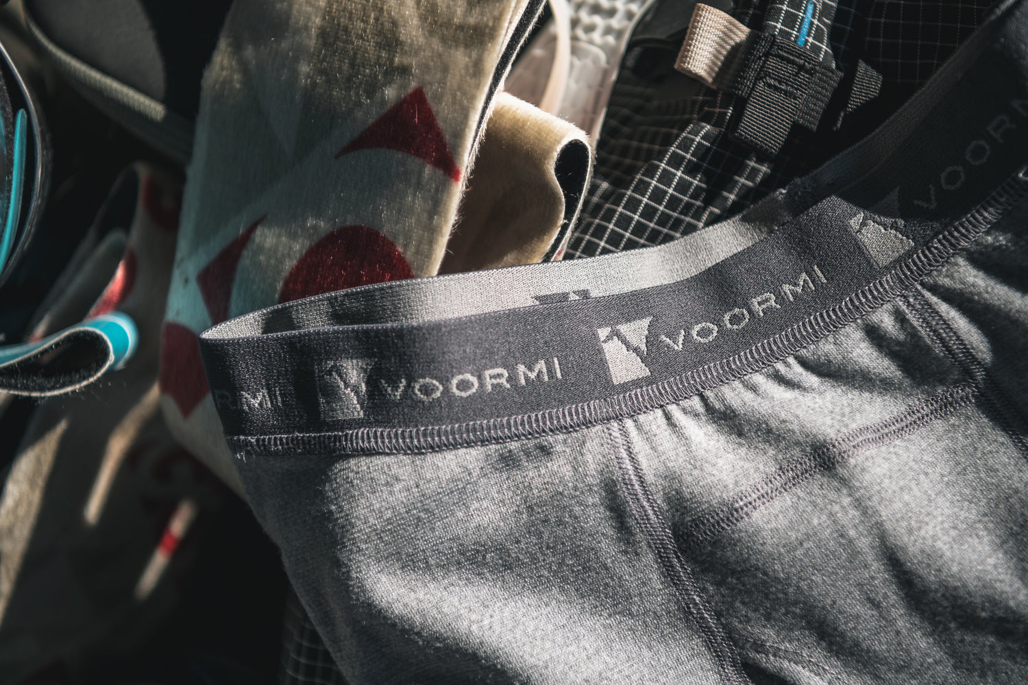 MEN'S BASELAYER BOTTOMS LAID OUT AMONG SKI SKINS